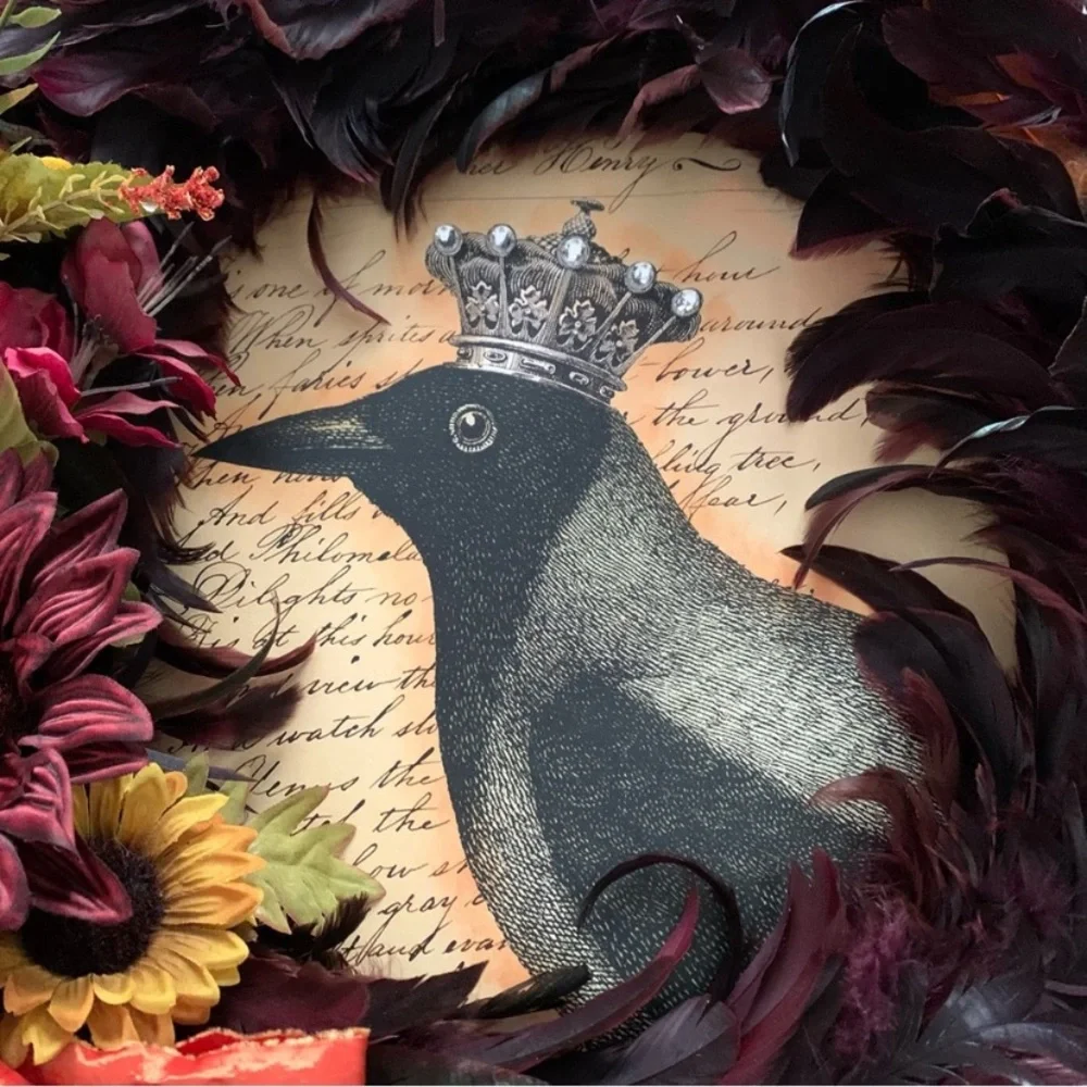 Dark red and black feather wreath with fall floral and a crowned crow center